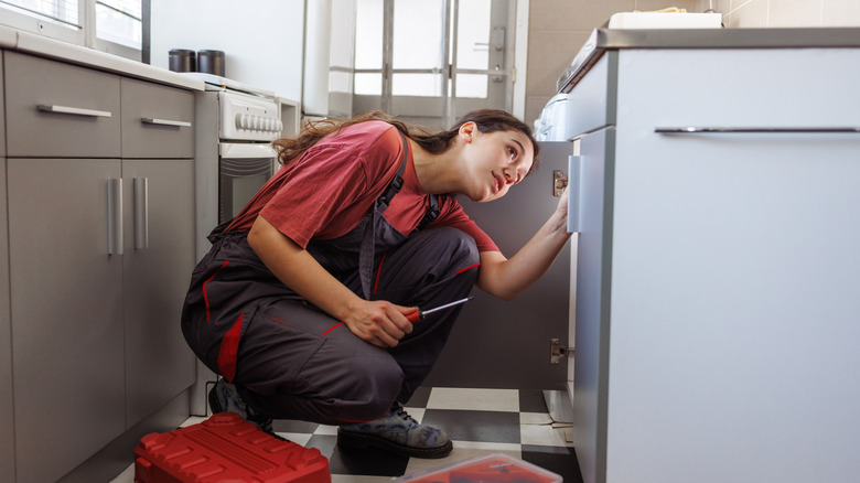 A person installing a sink.