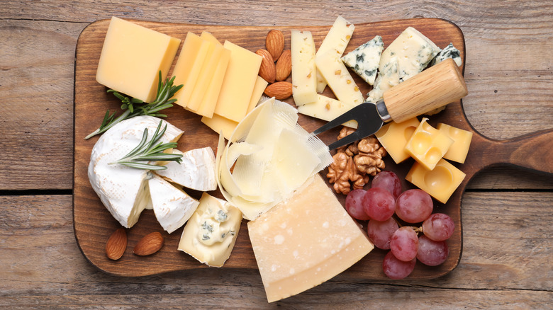 cheese board with parmigiano reggiano, swiss, and another hard cheese 