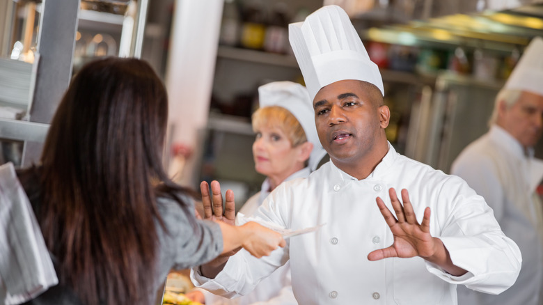 Chef receiving order ticket