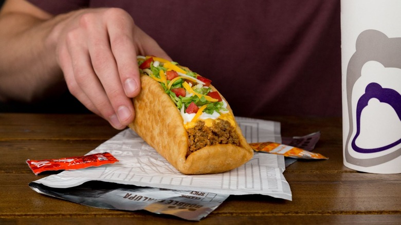 A Taco Bell taco with beef, cheese, and other ingredients