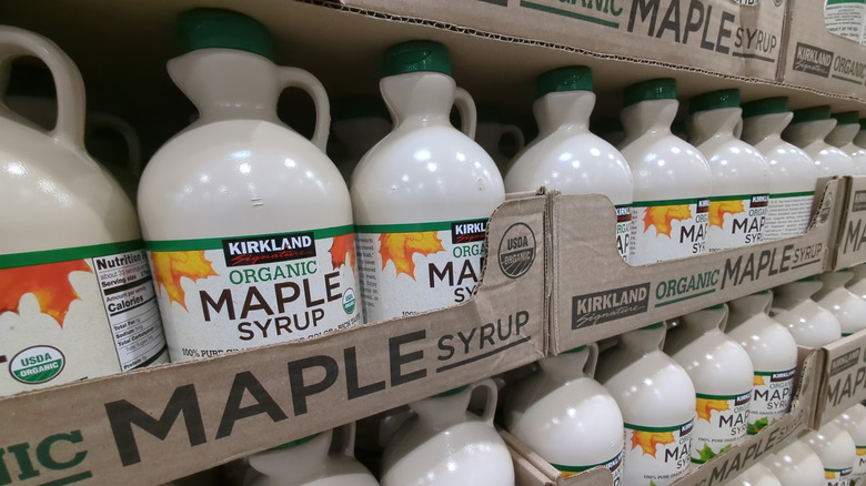 Stacks of Kirkland Signature Maple Syrup on the shelf