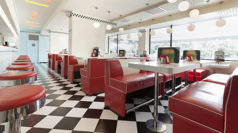 Diner interior with red vinyl booths and bard