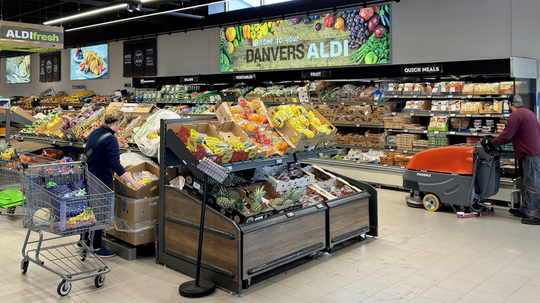 Shoppers in the produce section of an Aldi store