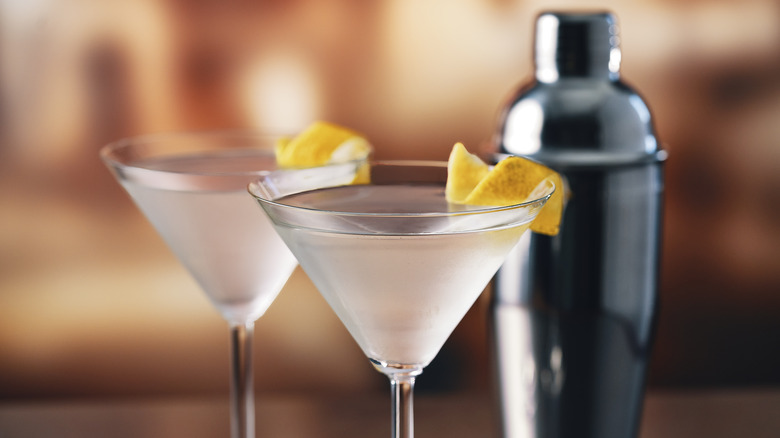 two martinis, lemon peel garnish