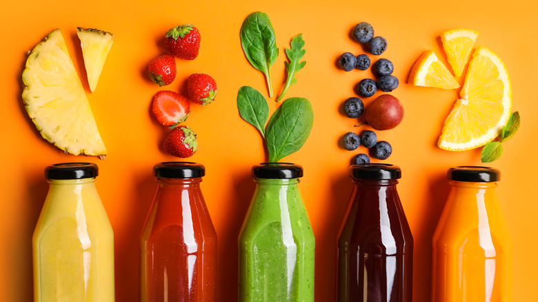 different juice varieties in bottles and their fruits