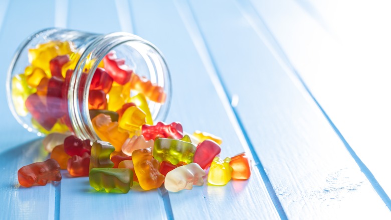 gummy bears spilling out of glass jar