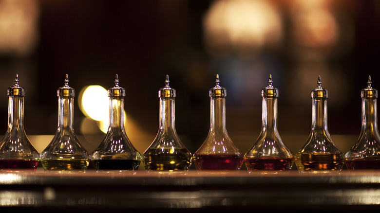 Bottles of bitters lined up on a bar