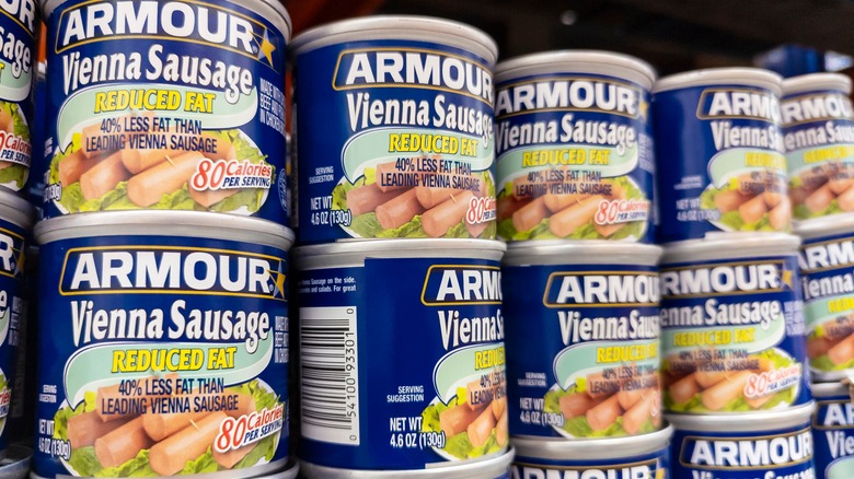 Stacks of Vienna sausages in a can on a shelf at a grocery store