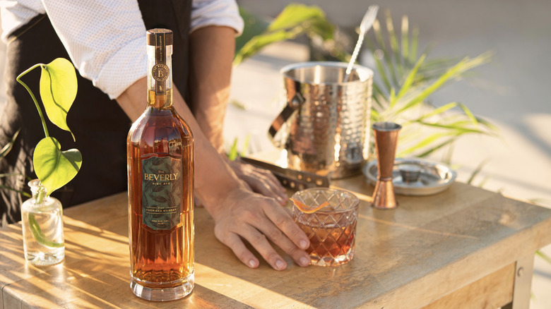 Bottle of whiskey on sunny bar