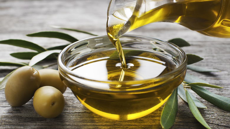 Olive oil poured into bowl 