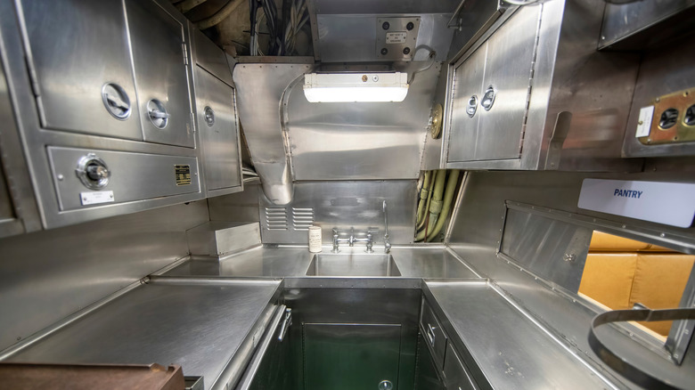 A submarine's galley gleams in stainless steel.