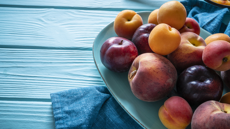 Stone fruits on blue