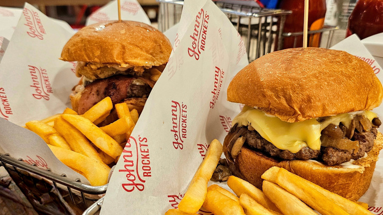 Freshmade Johnny Rockets burgers with cheese, bacon, and pickles and a side of fries