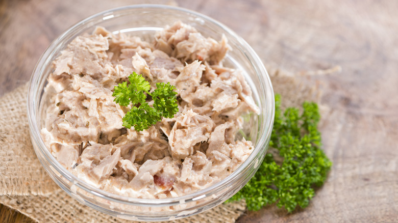 Tuna salad in a clear bowl with garnish
