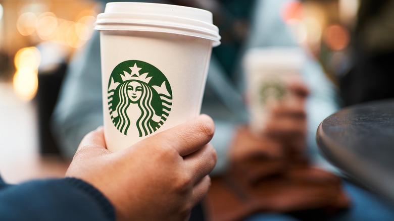 Person holding a Starbucks cup