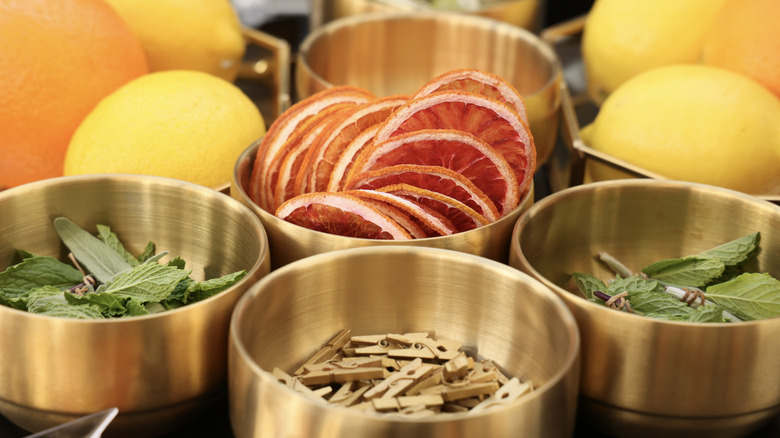 various cocktail garnishes including citrus and herbs