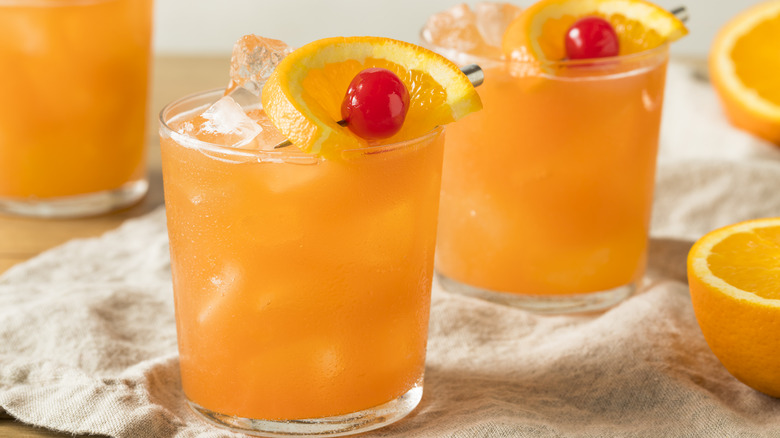 cocktail with orange and cherry flag garnish