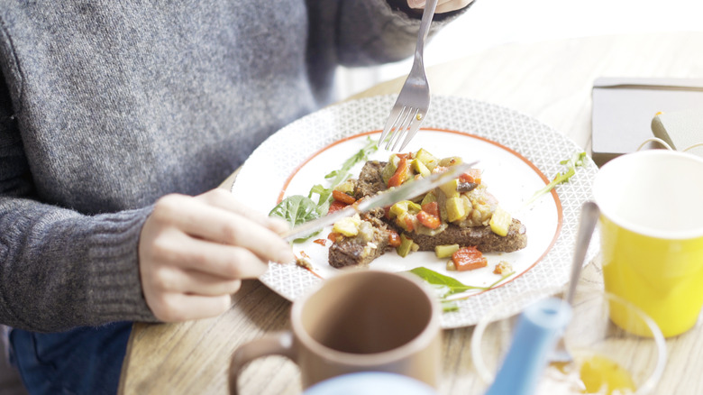 Eating tartine with fork and knife