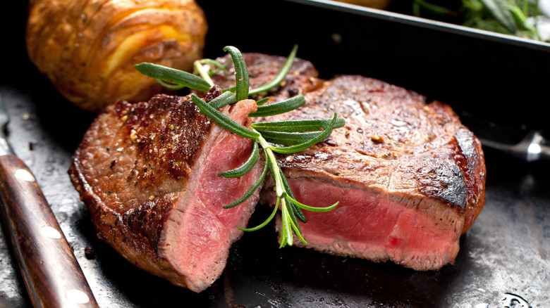 A seared steak alongside a potato