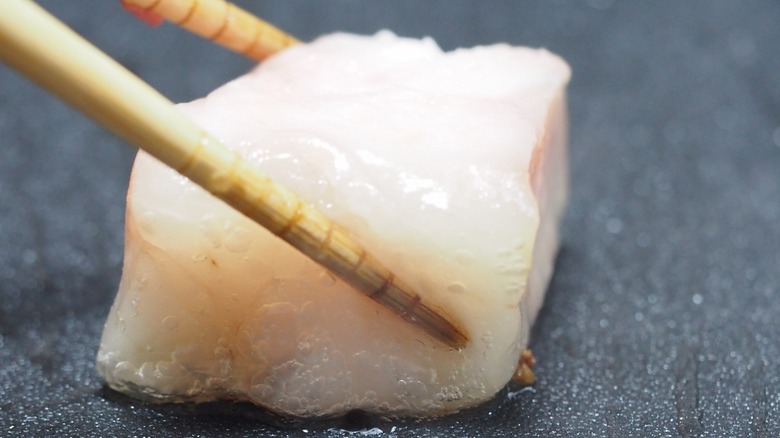 beef tallow chunk melting on a griddle