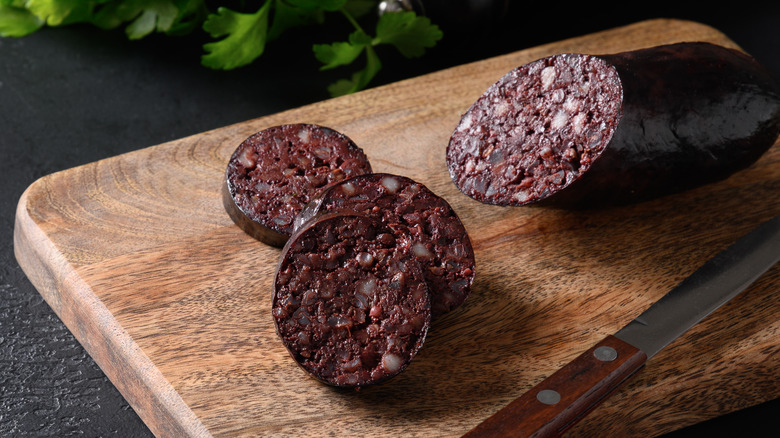 Cutting board with blood sausage and knife