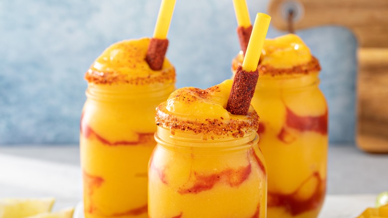 Mangonadas with chamoy, mango, and tamarind straw