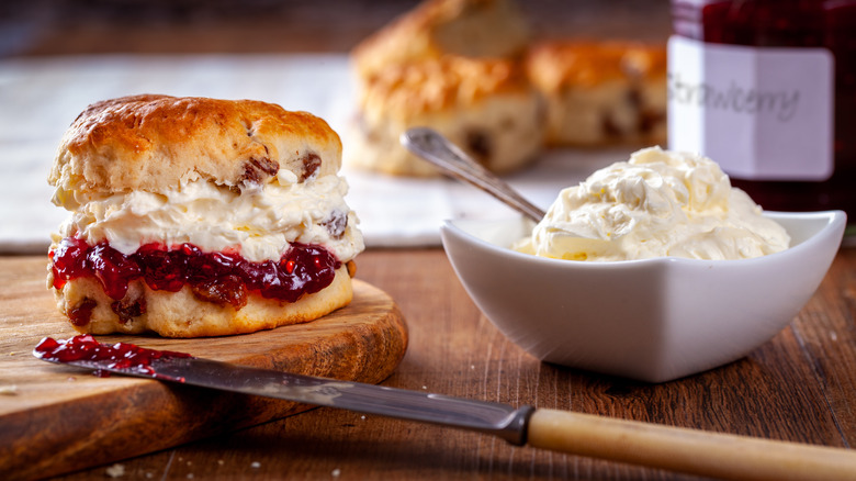 Scone stuffed with clotted cream and strawberry jam