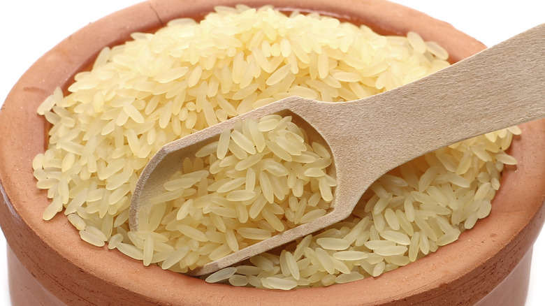 raw converted parboiled rice in stone bowl