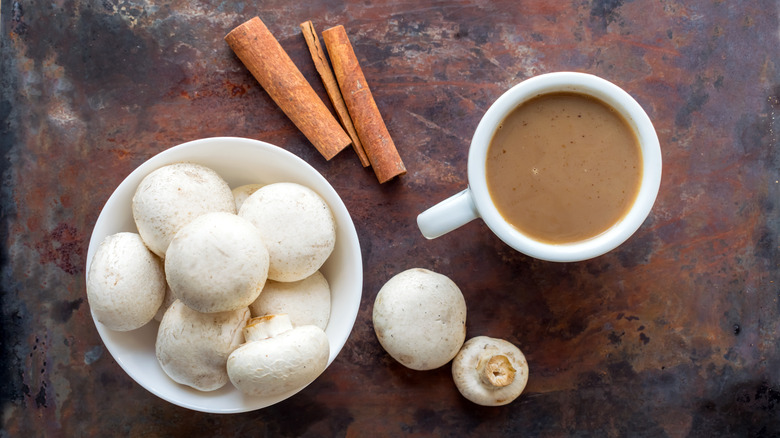 overhead shot of mushroom coffee with fresh whole mushrooms