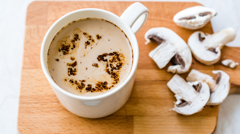 mushroom coffee and sliced mushrooms on cutting board