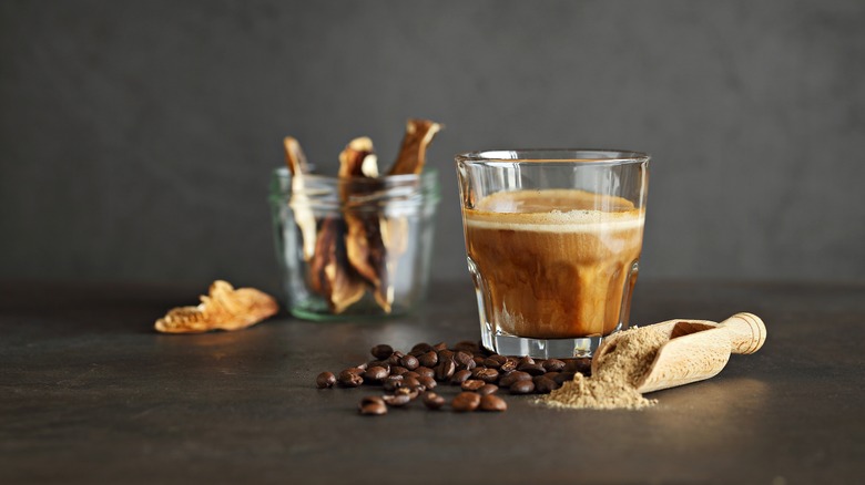 mushroom coffee in glass on dark background