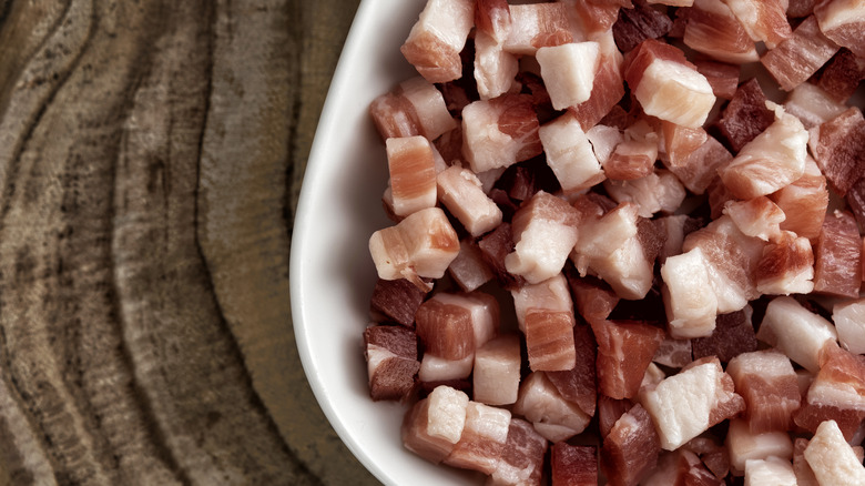 cubed raw pancetta in pan