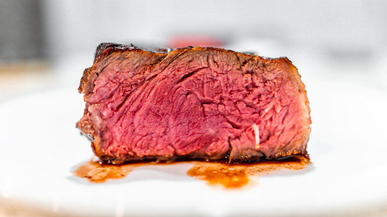 Strip steak half cut cooked rare
