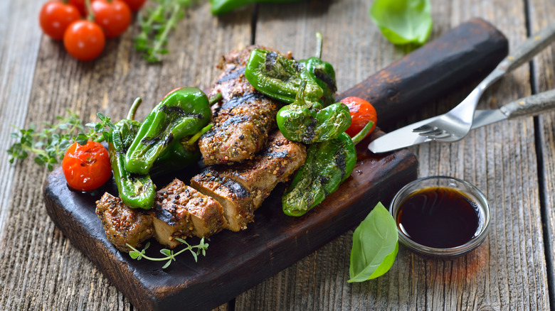 Grilled seitan with spicy peppers, tomatoes, and fresh herbs