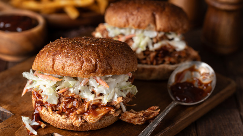 A plate of pulled chicken barbecue sandwiches topped with coleslaw