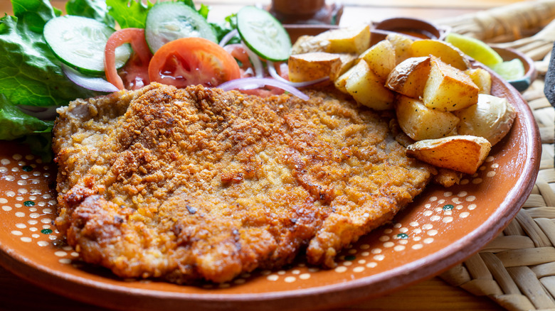 Steak milanesa with potatoes and salad