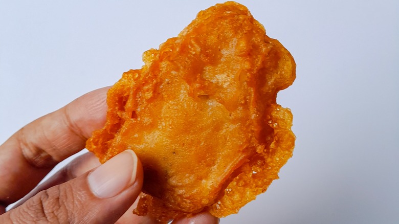 hand holding fried tempeh
