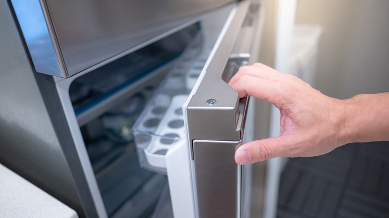hand opening fridge