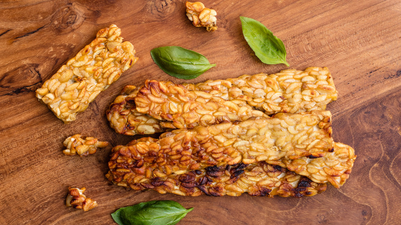cooked tempeh slices with basil