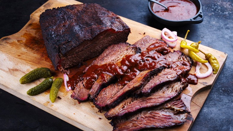 Smoked and sliced brisket on wooden board