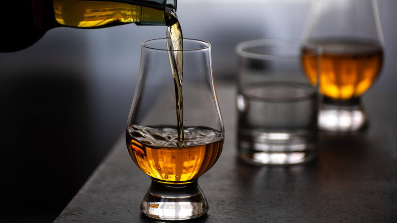 Pouring whiskey into a tulip glass
