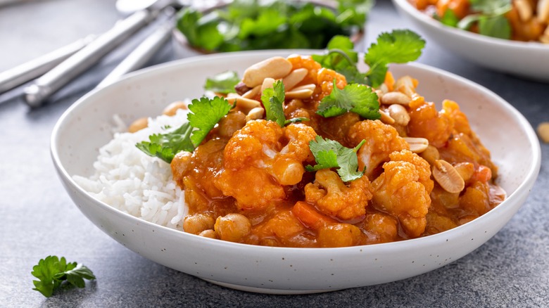 A bowl of curry with cilantro on top
