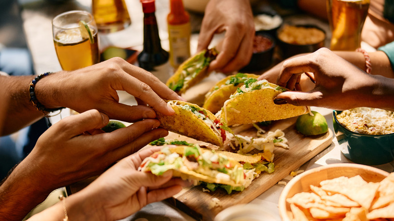 Diners enjoying tacos at restaurant