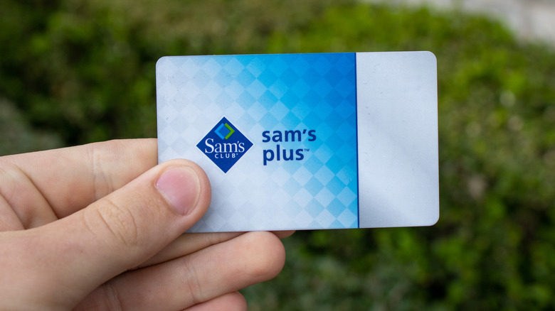 Hand holding a Sam's Club membership card