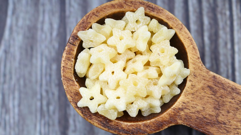 Raw stelline pasta in a spoon, view from the top