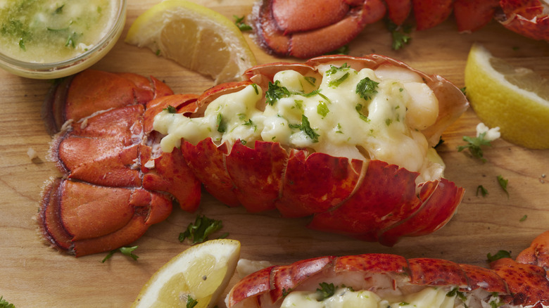 cooked lobster tail garnished with herbs