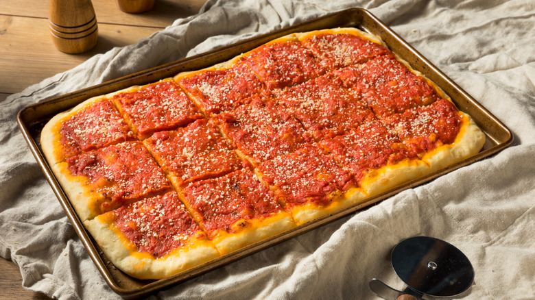 tomato pie in a sheet pan on top of a tablecloth