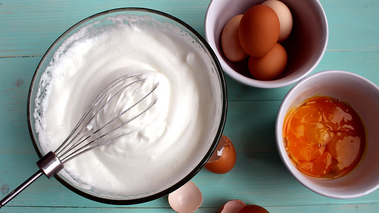 Frothy egg whites and separated yolks