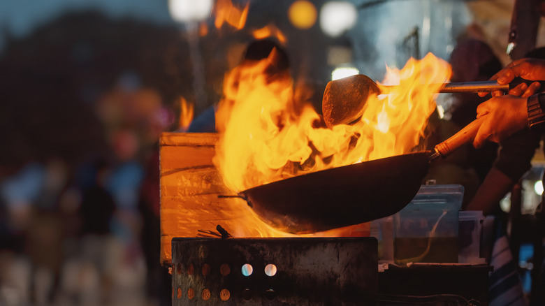 wok on fire over grill