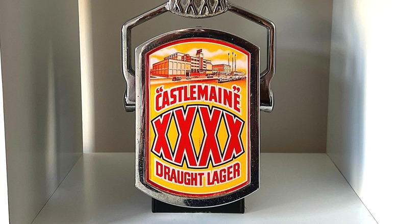 XXXX beer tap with logo on display